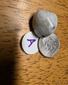 Stone found in candle with quarter for size