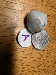 Stone found in candle with quarter for size